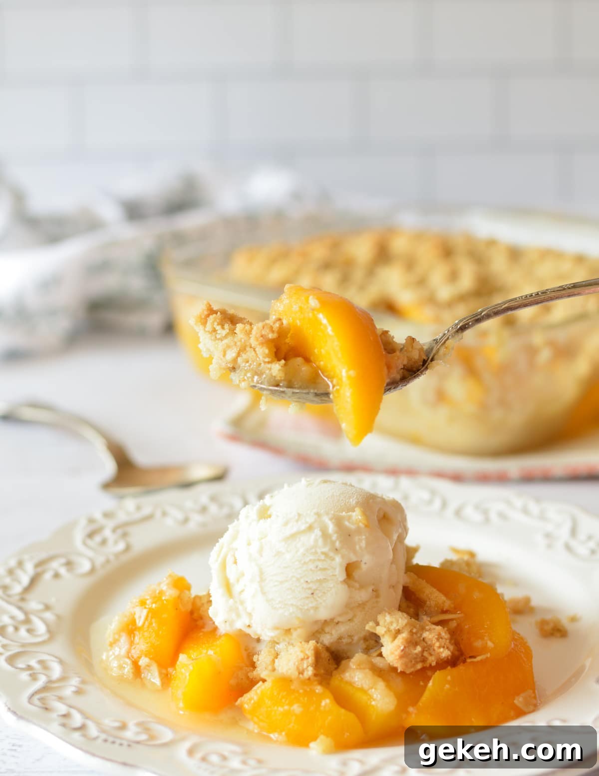 15+ Delicious Canned Peach Recipes for Every Meal 5 a forkful of peach crisp.