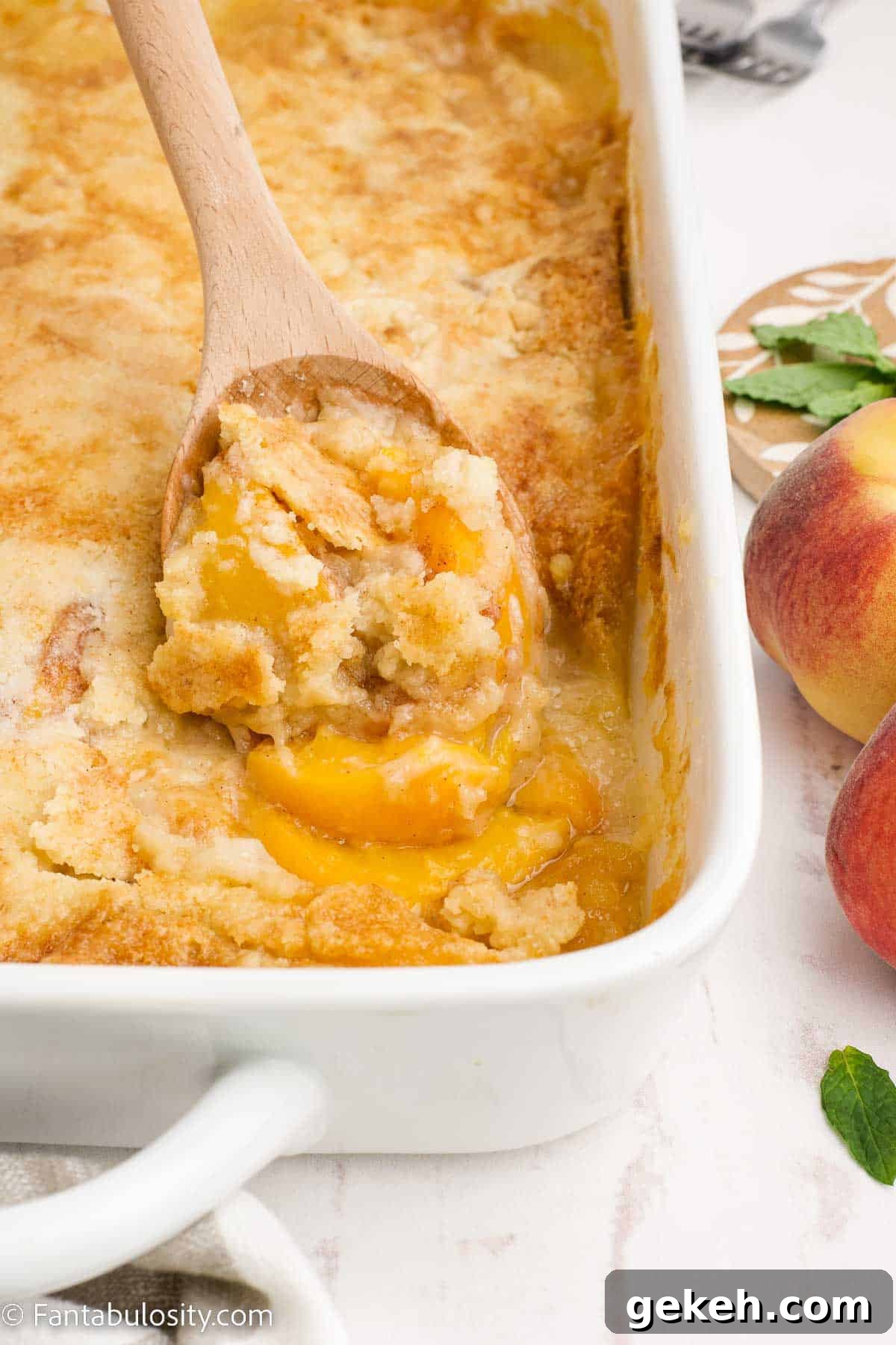 15+ Delicious Canned Peach Recipes for Every Meal 7 a large spoonful of peach cobbler.