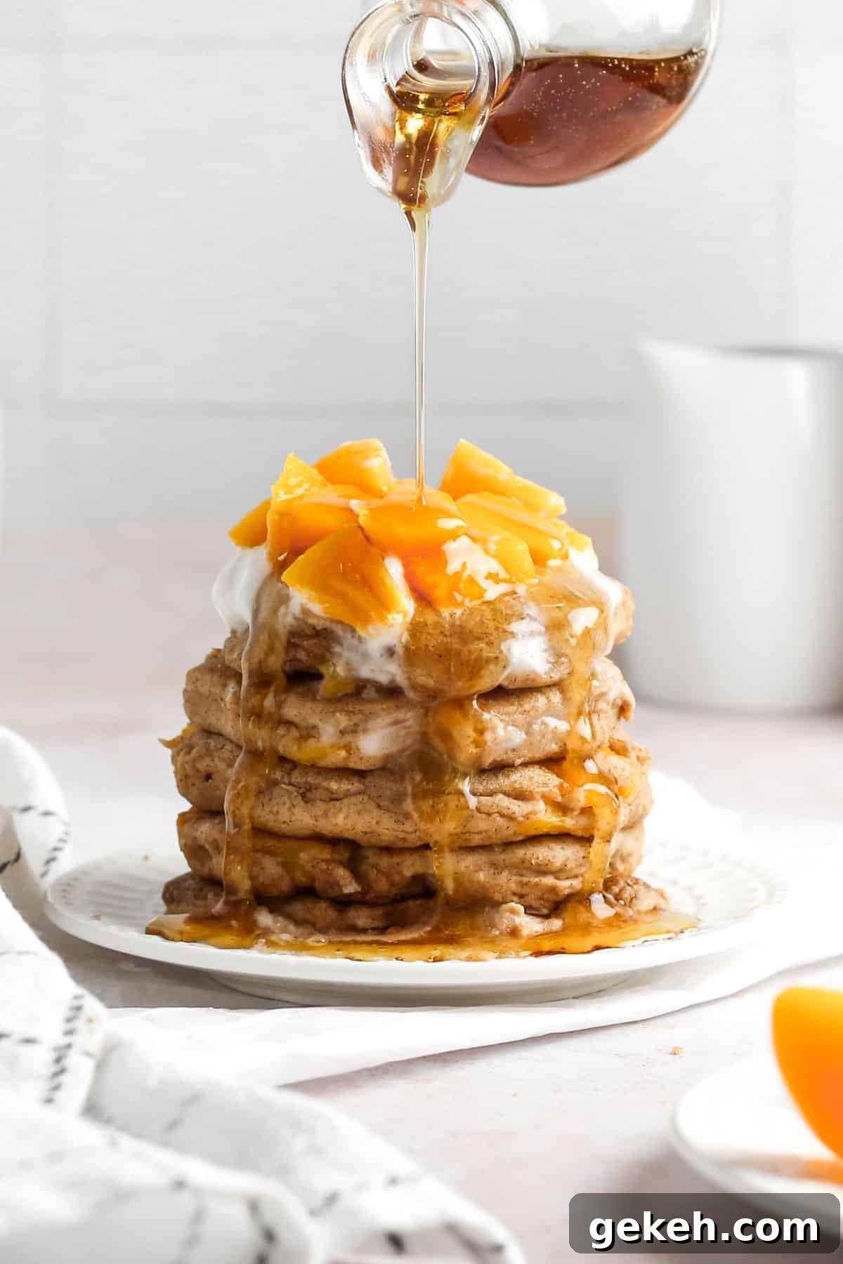 15+ Delicious Canned Peach Recipes for Every Meal 8 pancakes with peaches and syrup.