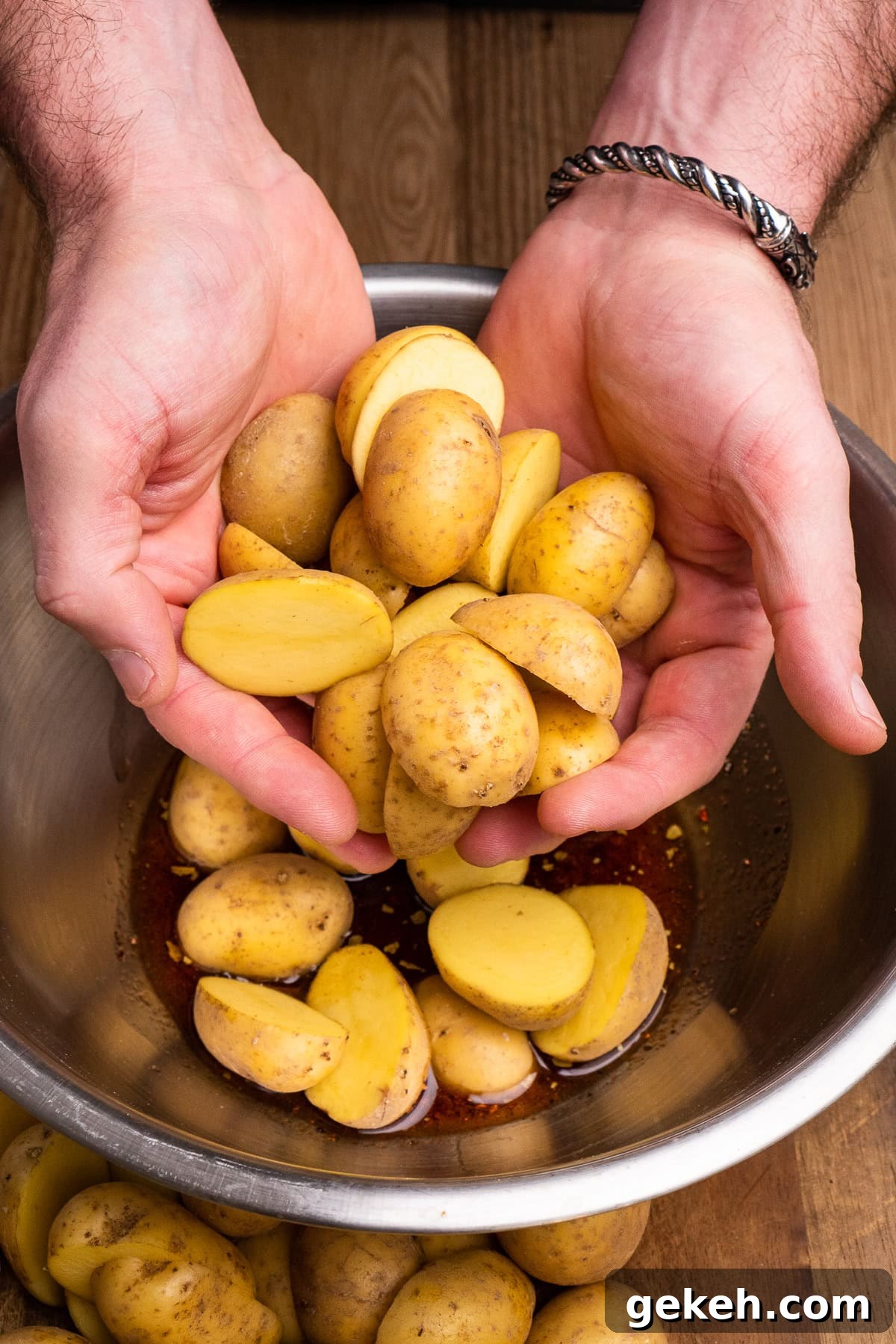 Crispy Air-Fried Baby Potatoes Recipe 16 Placing the chopped baby potatoes into the large mixing bowl by hand on top of the olive oil and piri piri seasoning