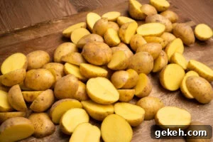 Crispy Air-Fried Baby Potatoes Recipe 5 Chopped baby potatoes spread out over a wooden chopping board