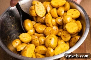 Crispy Air-Fried Baby Potatoes Recipe 7 Stirring the chopped baby potatoes together with olive oil and piri piri seasoning in a large mixing bowl