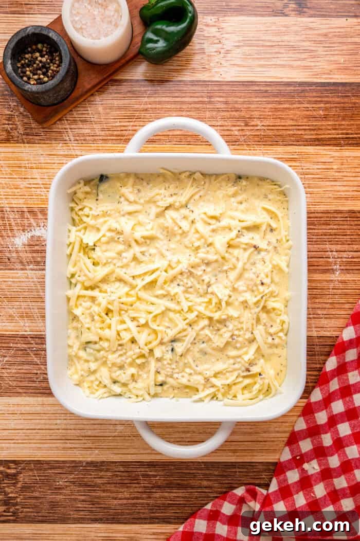 With layers of roasted poblano peppers and gooey cheese topped with fluffy eggs, this Chile Relleno Casserole is easy & flavorful. Eggs poured over layers of peppers and cheese