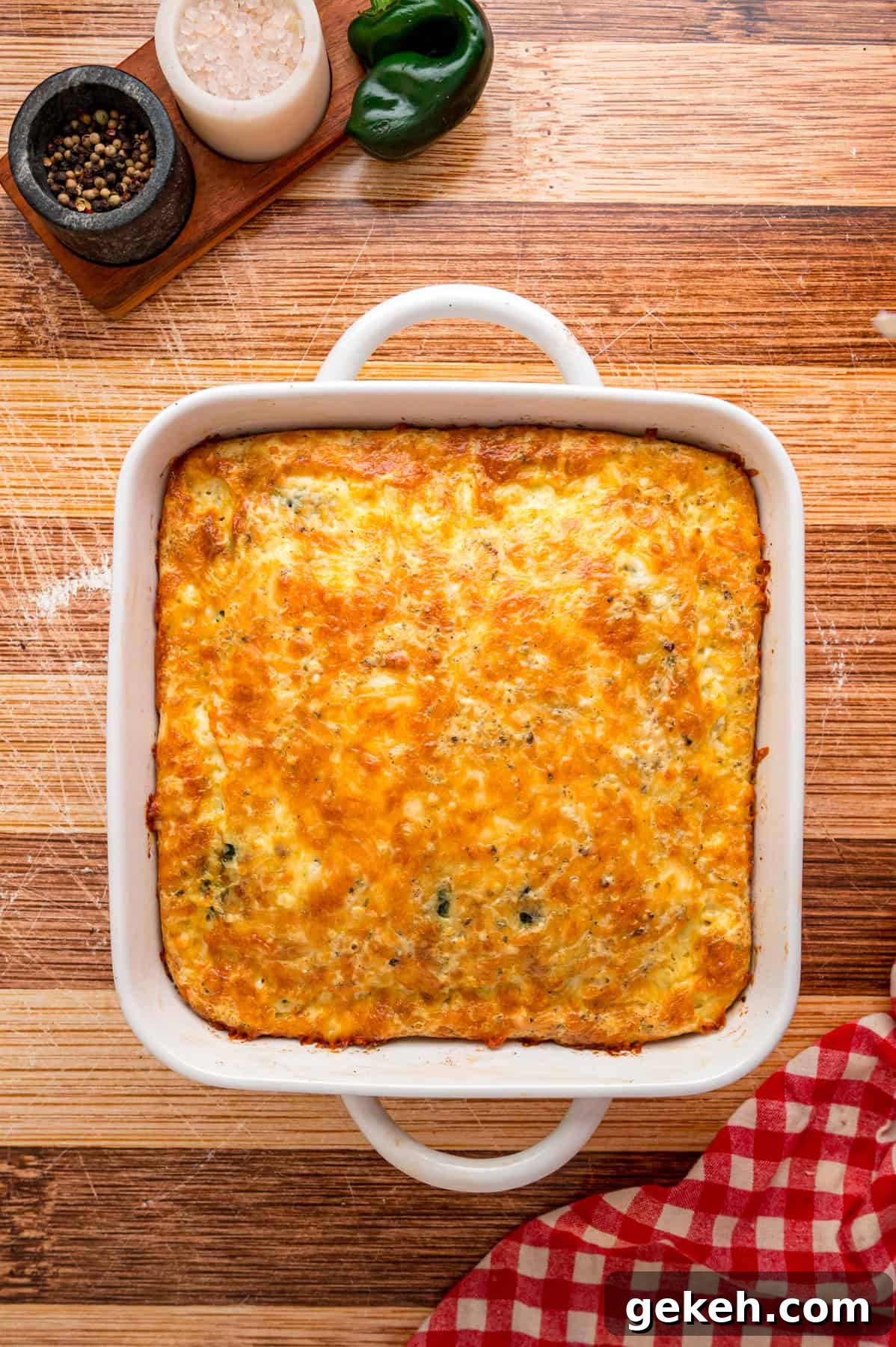 With layers of roasted poblano peppers and gooey cheese topped with fluffy eggs, this Chile Relleno Casserole is easy & flavorful. Overhead view of chile relleno casserole