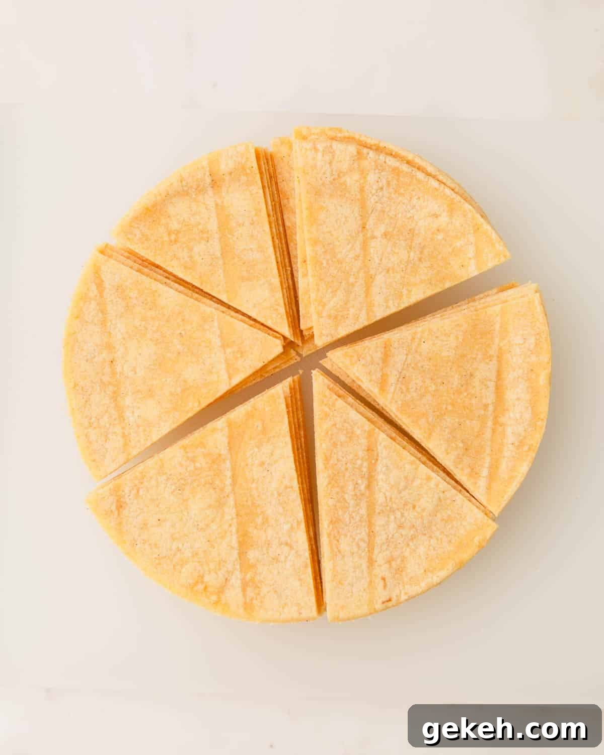 A stack of corn tortillas cut into six pieces.