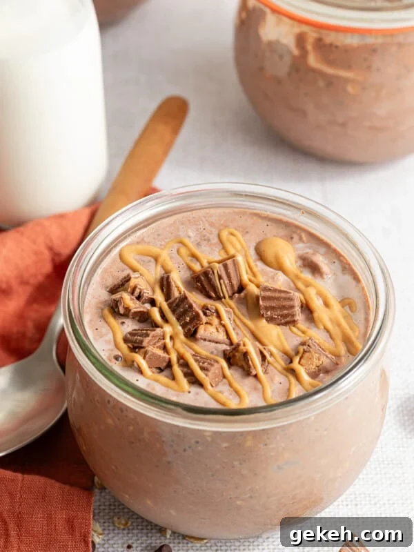 Chocolate peanut butter overnight oats topped with mini Reese's and a drizzle of peanut butter.