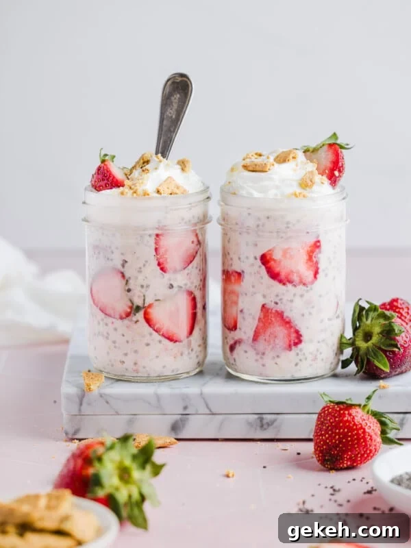 Strawberry cheesecake overnight oats with whipped cream, crumbled graham crackers and strawberries.