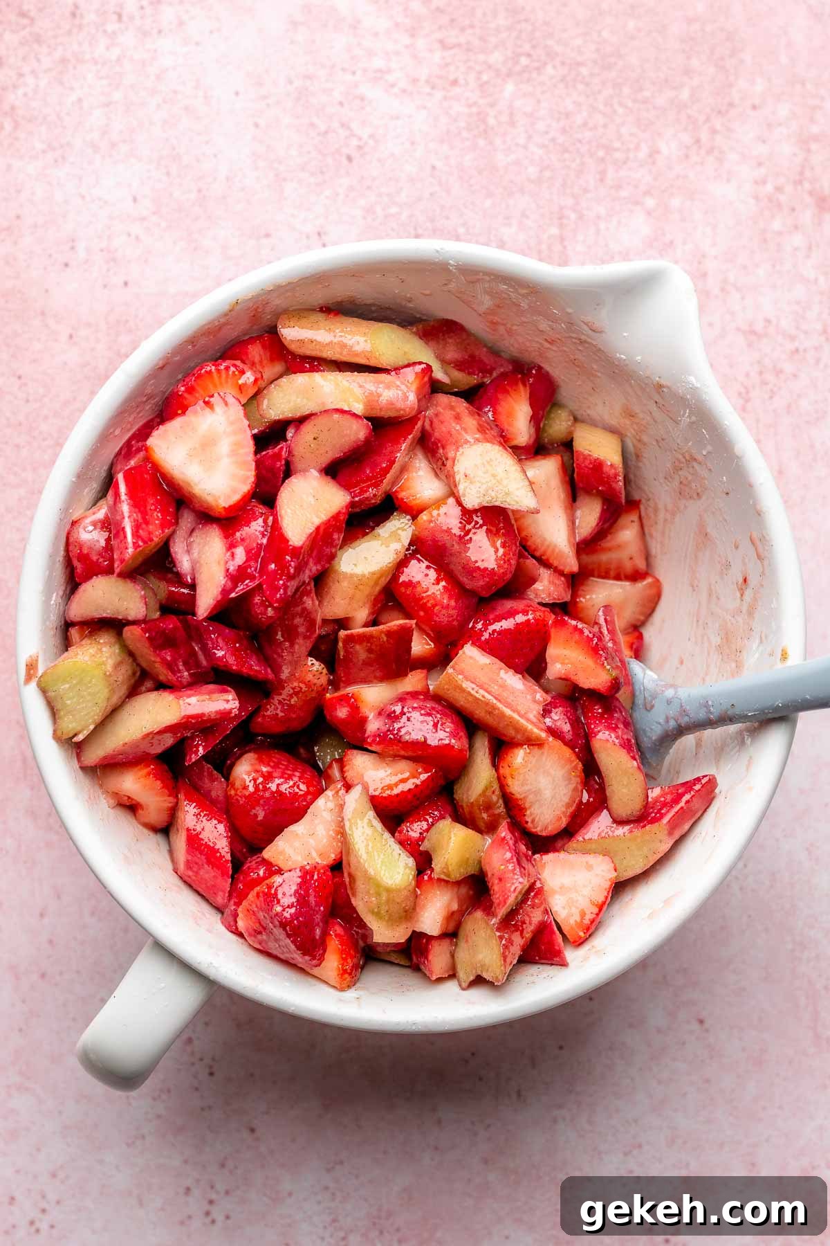 Strawberry Rhubarb Cobbler Recipe: Classic Summer Dessert 4 Strawberry and rhubarb pieces in a mixing bowl.