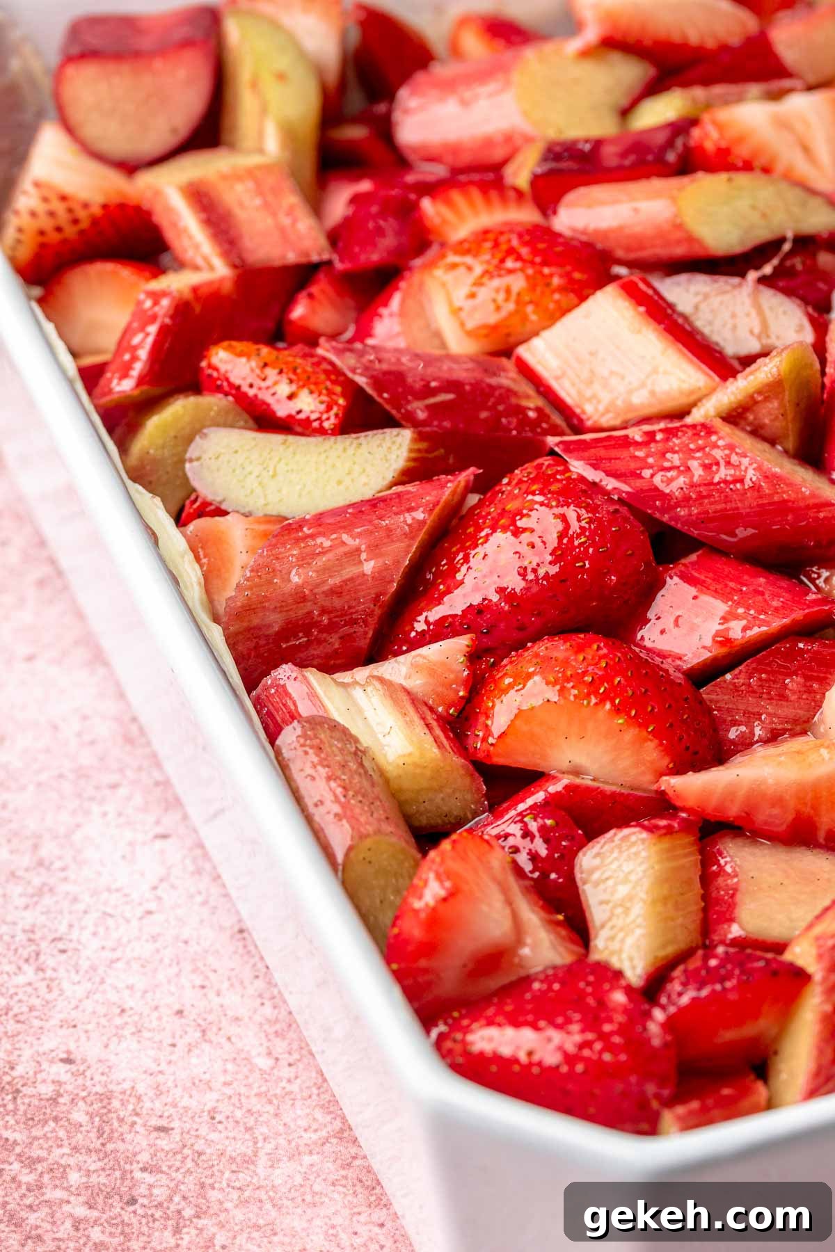 Strawberry Rhubarb Cobbler Recipe: Classic Summer Dessert 6 Strawberry and rhubarb filling in a casserole dish.