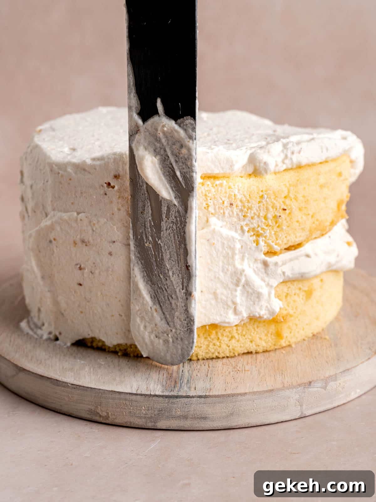 Homemade Almond Cream Cake Recipe for Moist, Decadent Slices 11 Frosting an almond layer cake with whipped cream frosting.
