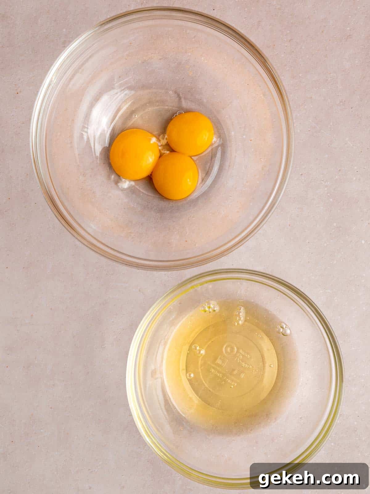 Homemade Almond Cream Cake Recipe for Moist, Decadent Slices 4 Three egg yolks and whites separated into two bowls.