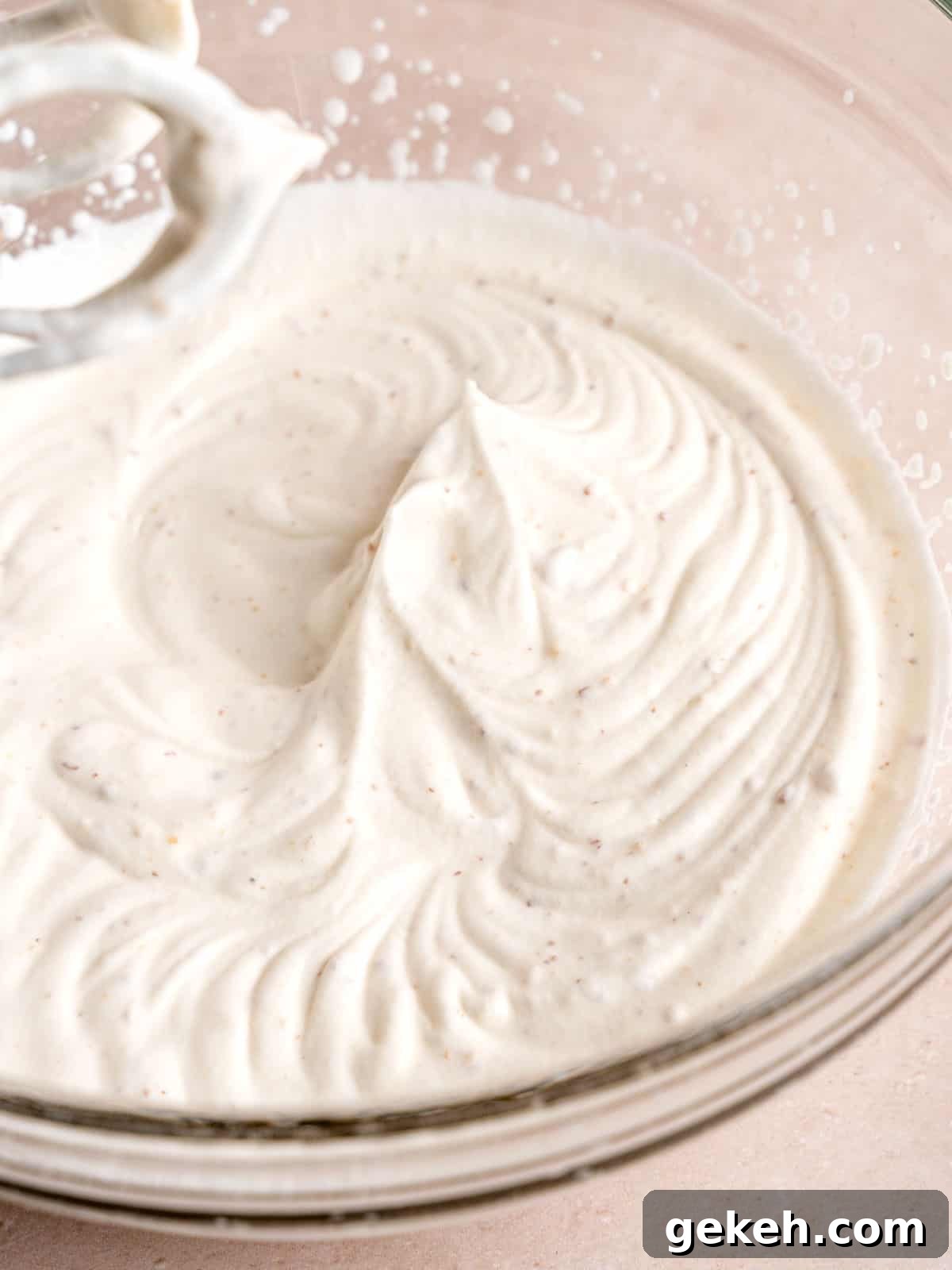 Homemade Almond Cream Cake Recipe for Moist, Decadent Slices 10 Whipping heavy cream with almond pastry filling to stiff peaks.