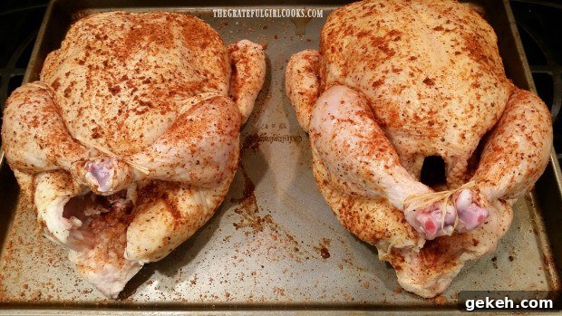 Two seasoned chickens with legs tied