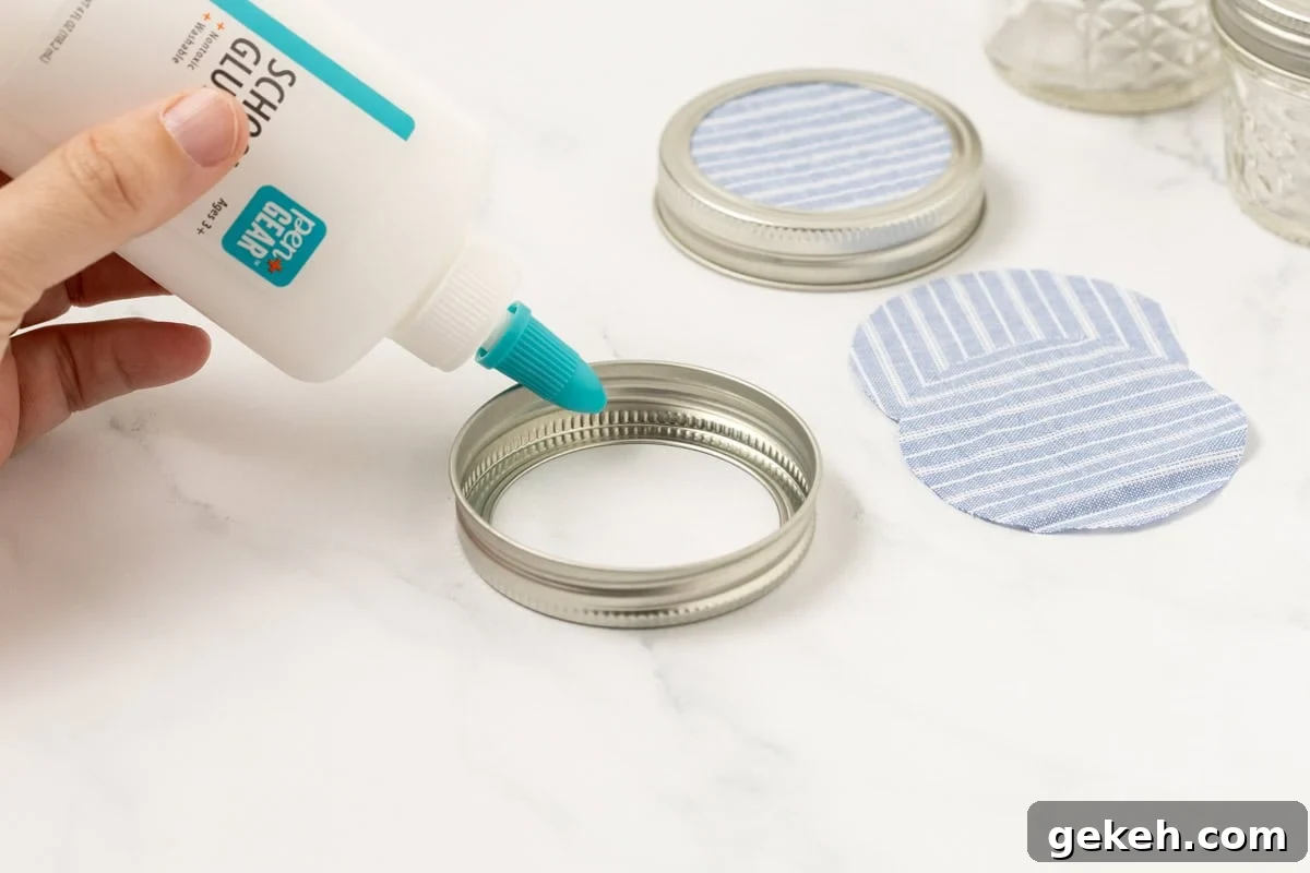 DIY Baking Soda Air Freshener with Natural Scents 5 fabric circles being glued onto a mason jar ring