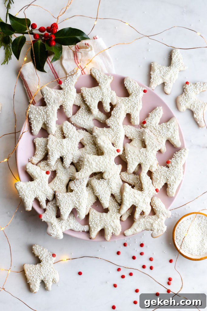 Festive Reindeer Cookies Recipe for Holiday Parties 24 Pink plate full of Reindeer Animal Cookies among fairy lights on a marble surface