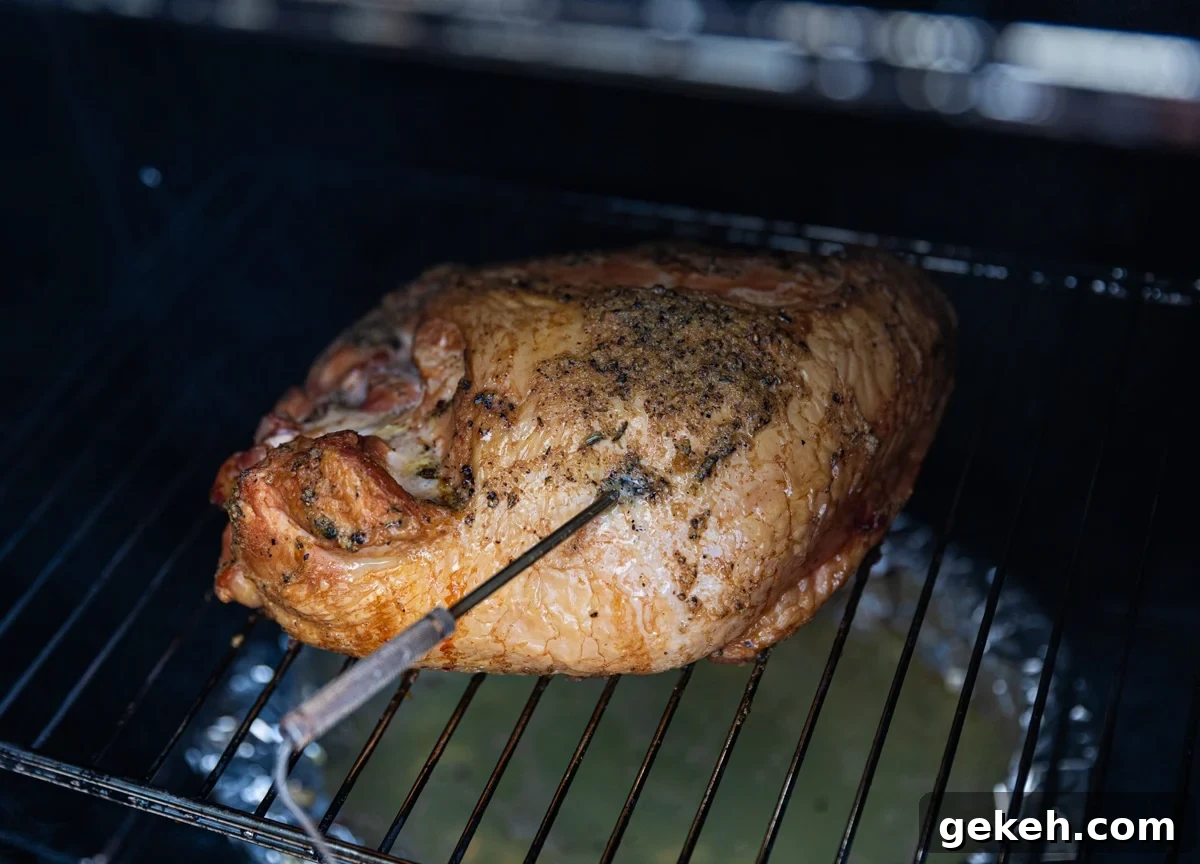 Turkey breast sitting on smoker racks.
