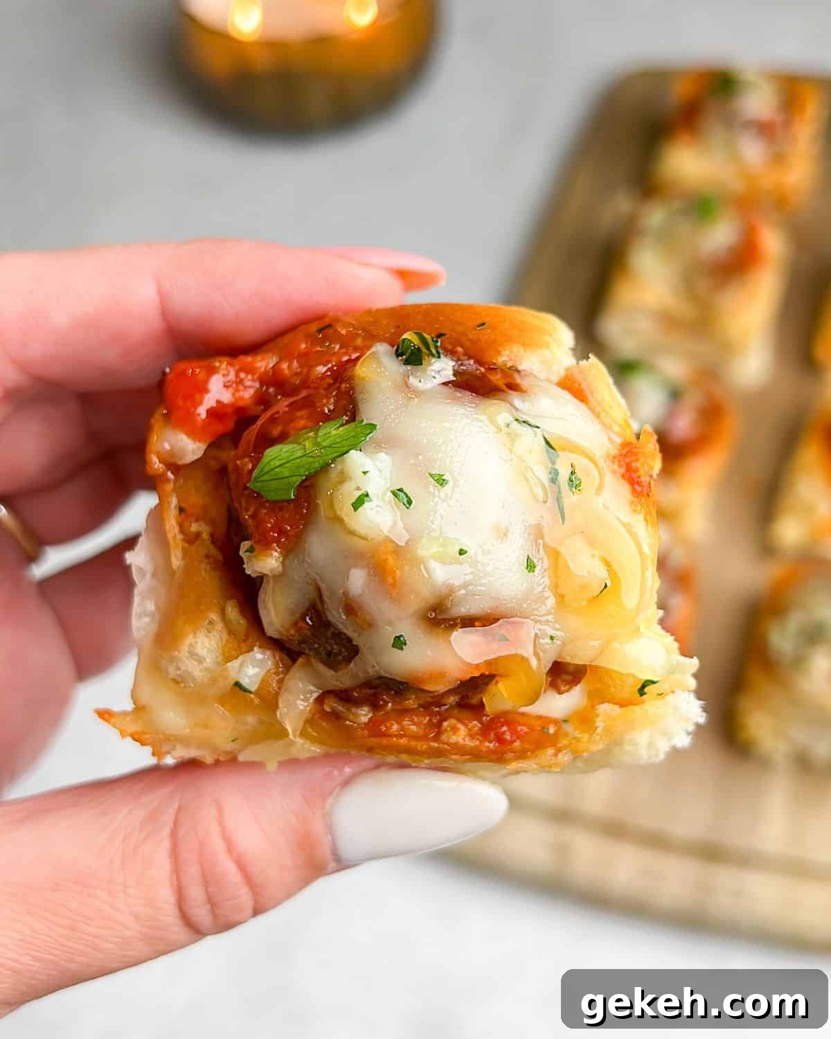 Hawaiian Roll Meatball Sliders with Tangy Pineapple Glaze 2 meatball sliders with melted cheese on top and hot honey