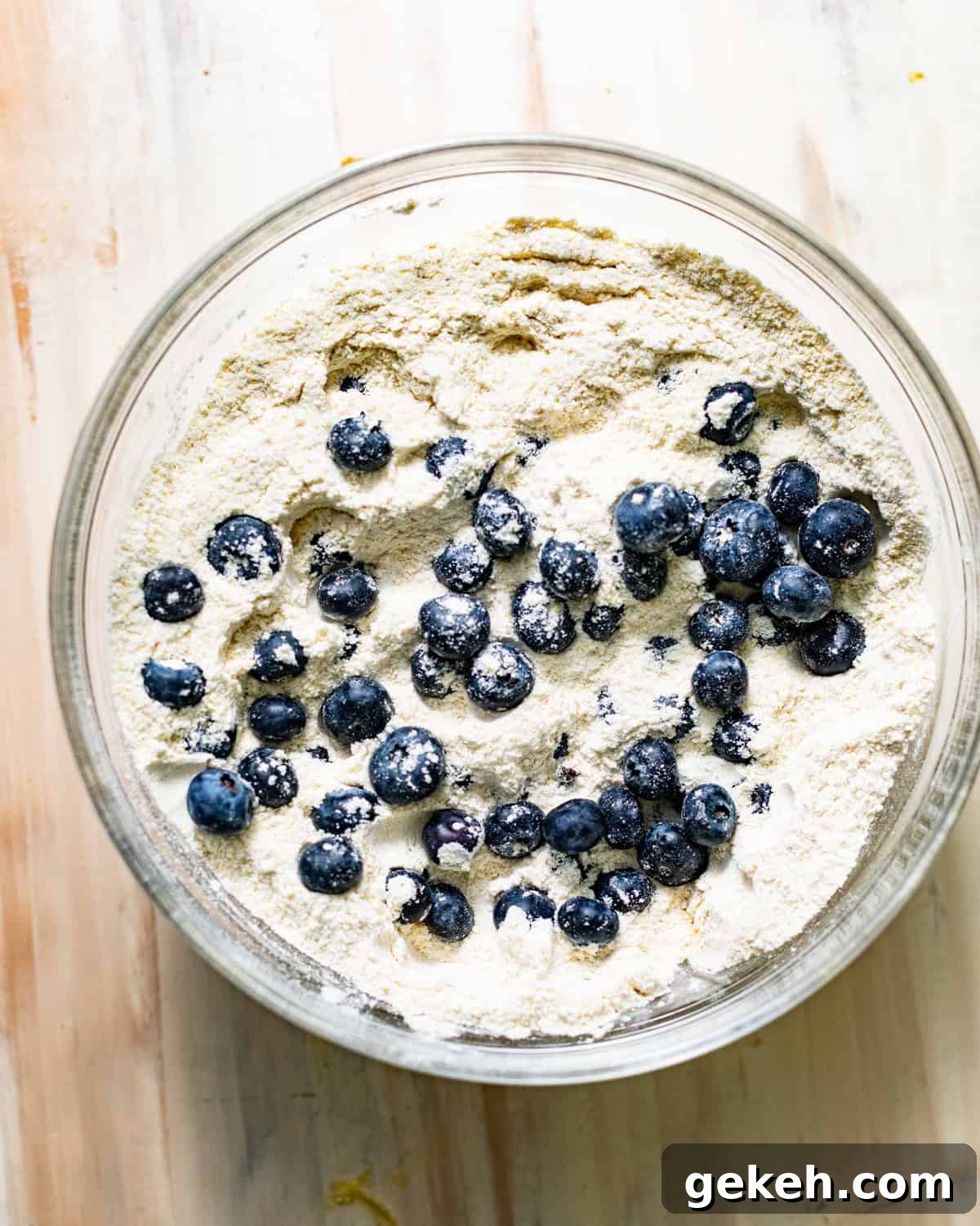 Moist Lemon Blueberry Pound Cake Recipe 3 blueberries tossed in a bowl with the dry ingredients.