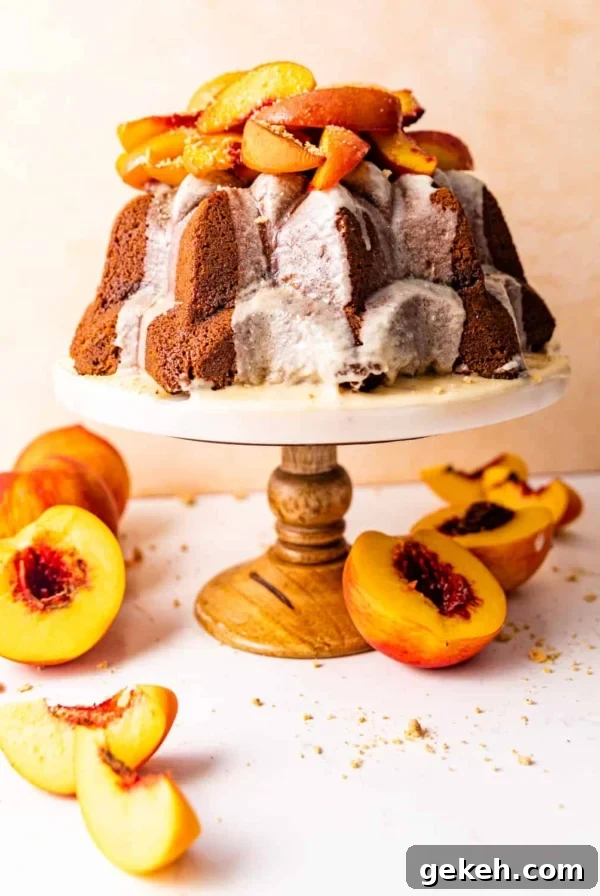 Moist Lemon Blueberry Pound Cake Recipe 10 pound cake on a cake stand topped with roasted peaches.