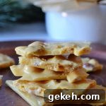 a stack of peanut brittle pieces on a copper tray