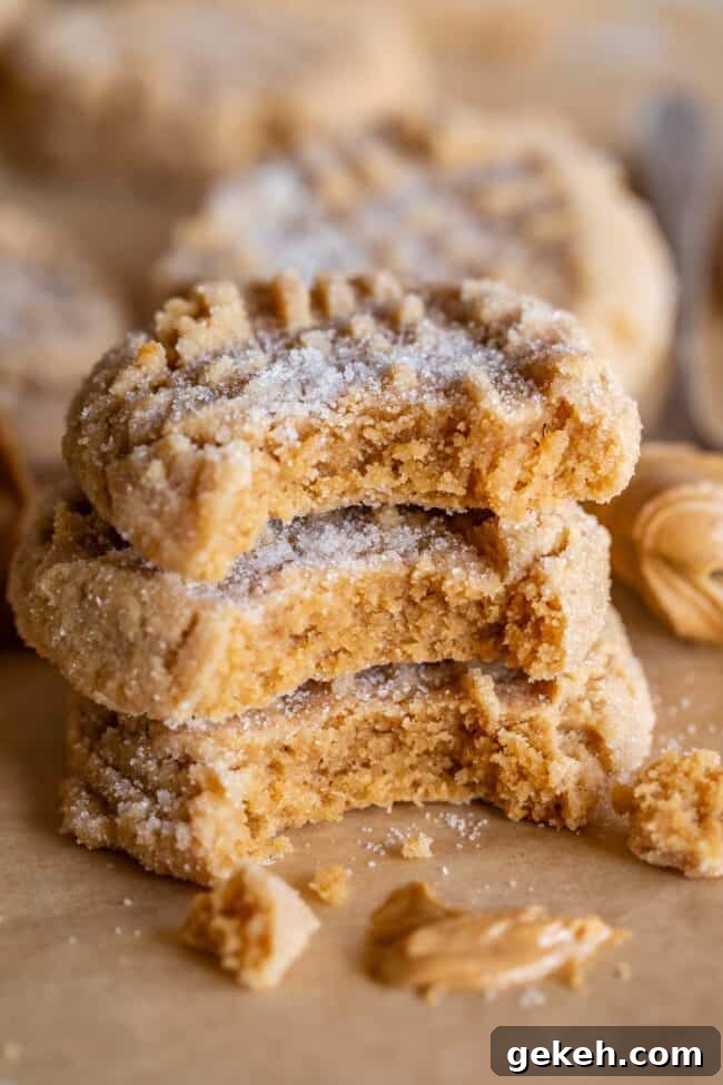 Chewy Peanut Butter Cookie Recipe That Melts in Your Mouth 5 stack of 3 soft peanut butter cookies, each with a bite taken out.