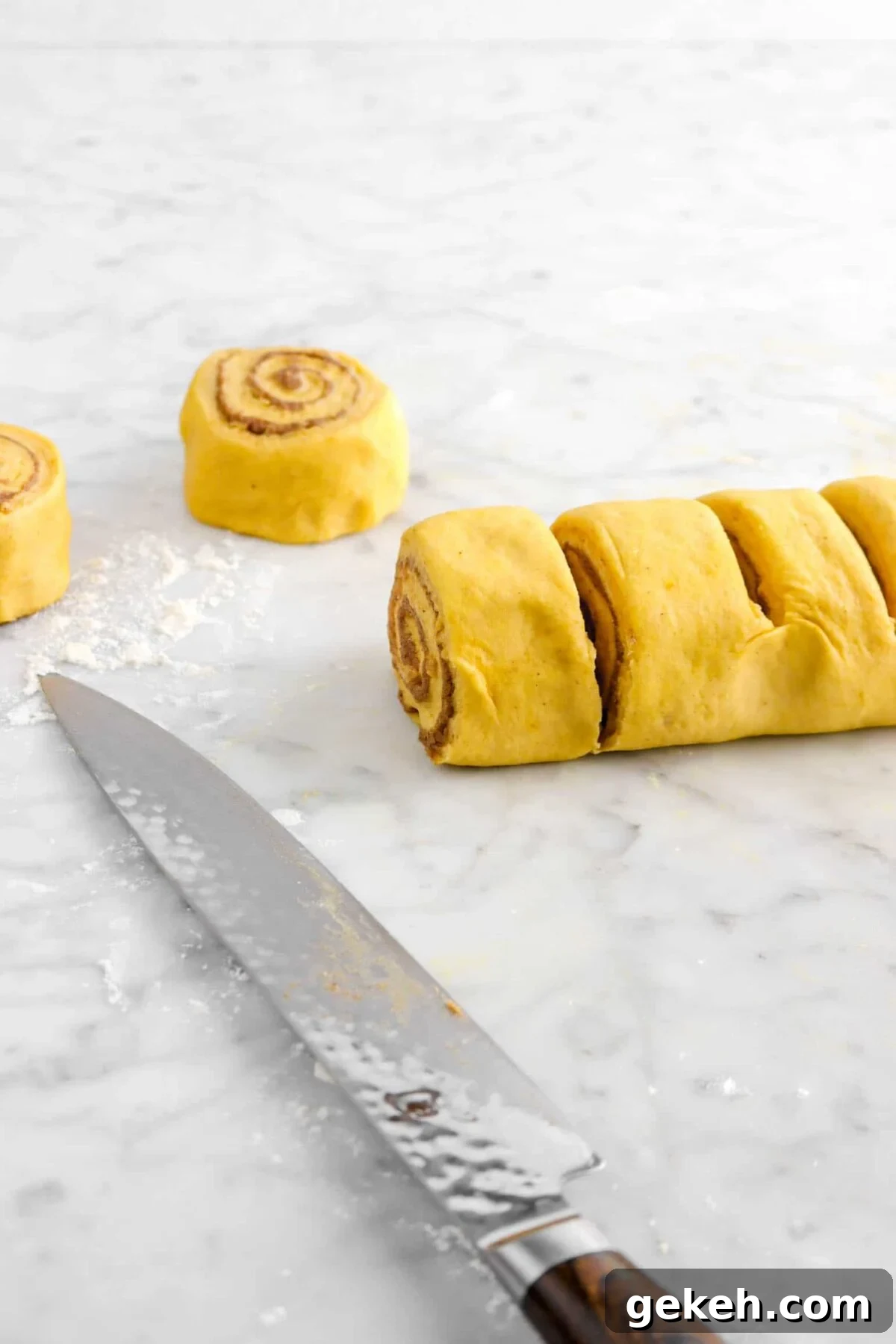 pumpkin cinnamon rolls being cut