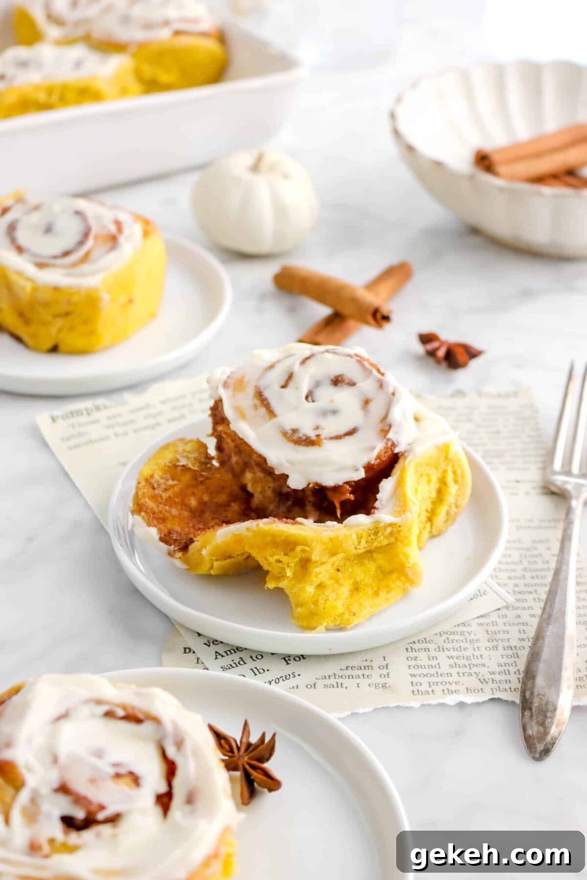 pulled apart pumpkin cinnamon roll on white plate