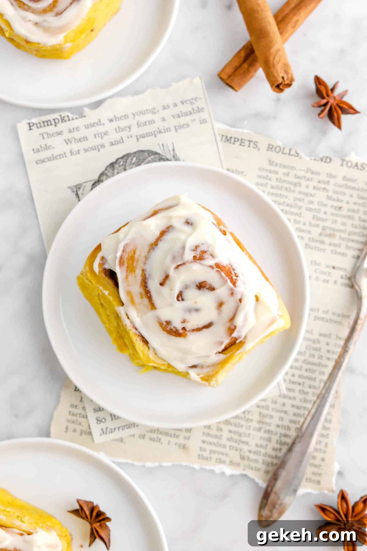 overhead of pumpkin cinnamon roll on white plate