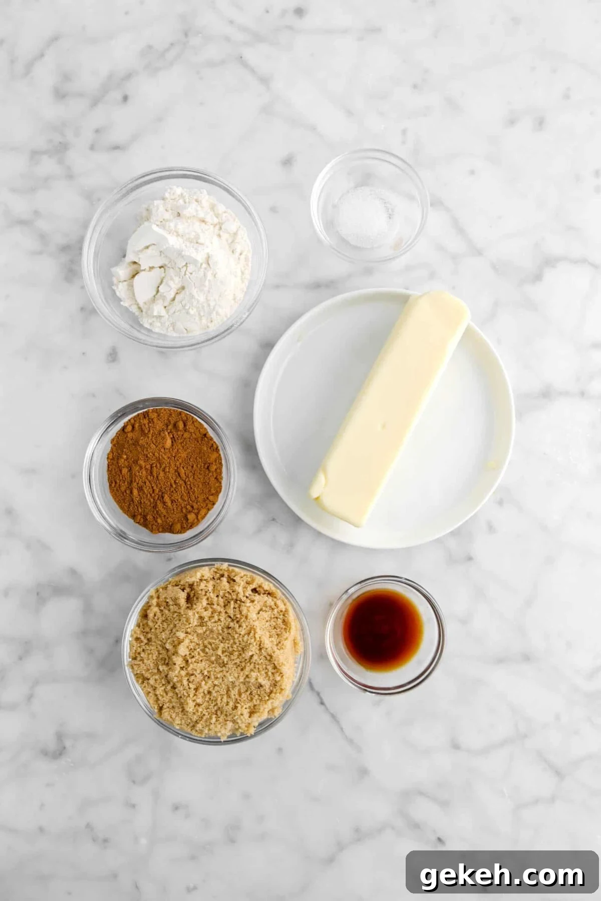 salt, flour, pumpkin pie spice, brown sugar, vanilla, and butter on marble counter