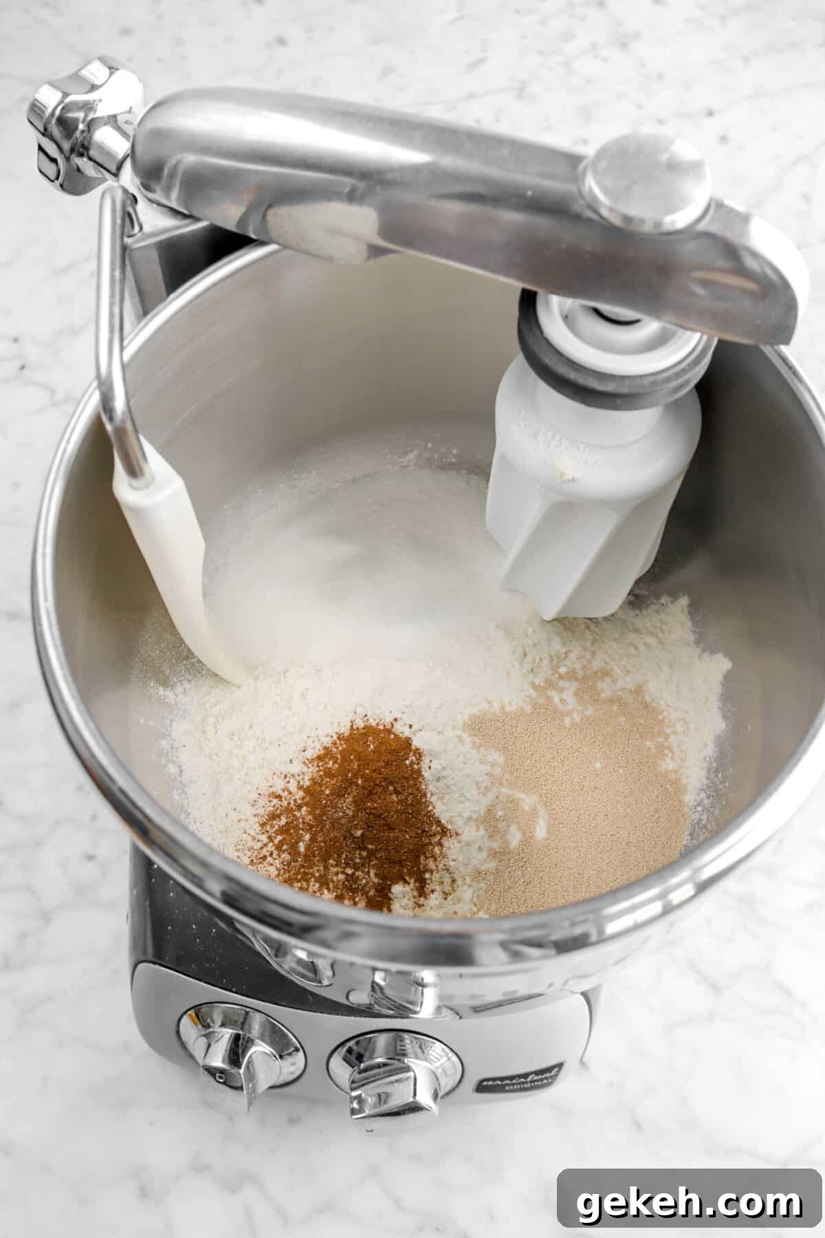 flour, sugar, spice, and yeast in mixer
