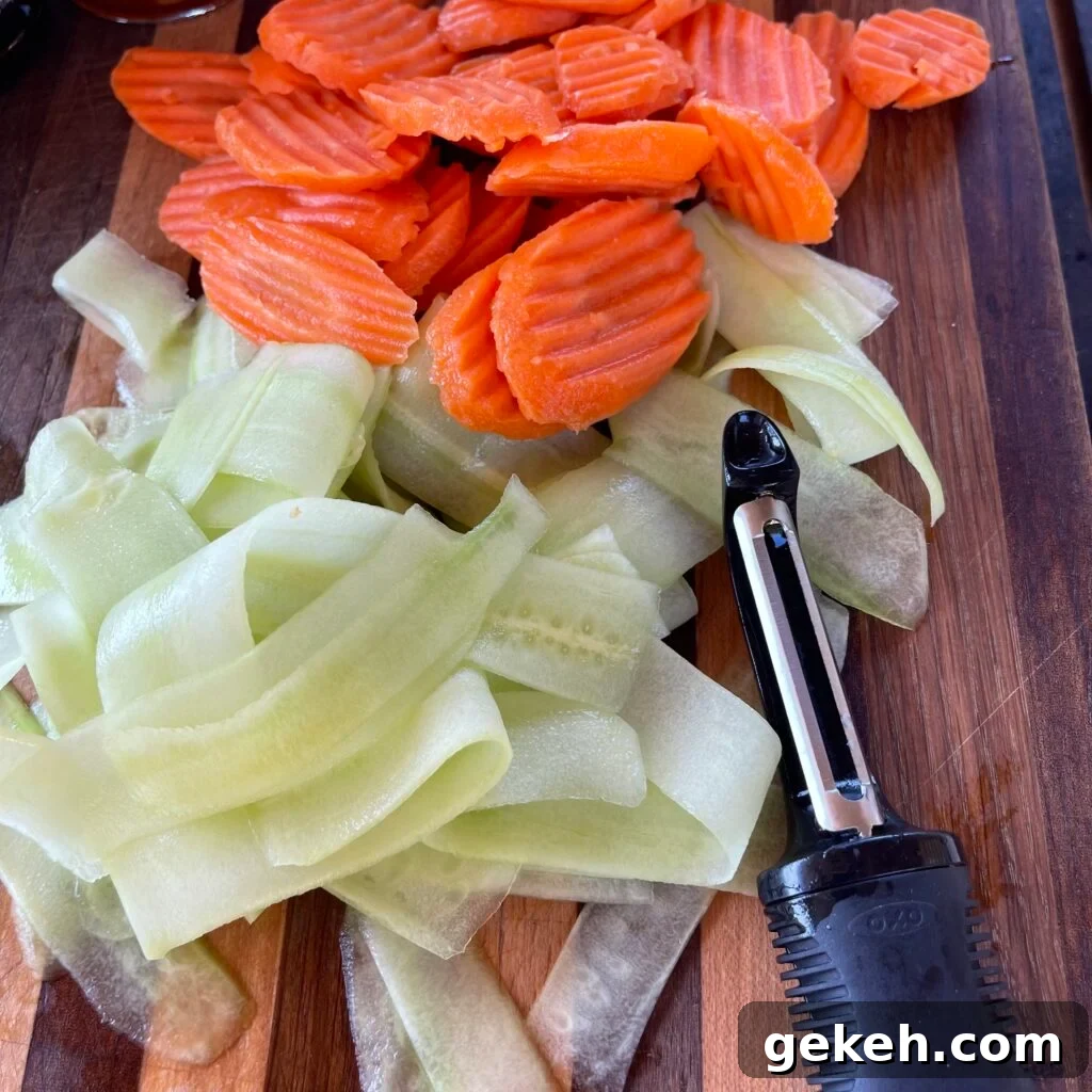 Thai-Style Grilled Chicken with Tangy Marinade 5 sliced cucumber and carrots on cutting board.