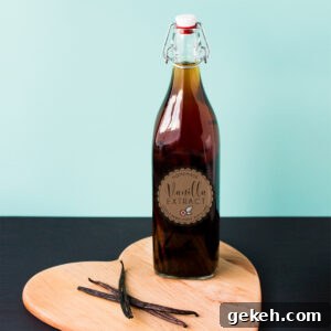 Homemade Vanilla Extract Infused with Rum: Step-by-Step Guide 10 A bottle of vanilla extract made with rum, in a tall swing-top bottle, on a heart shaped wooden board with three vanilla beans.