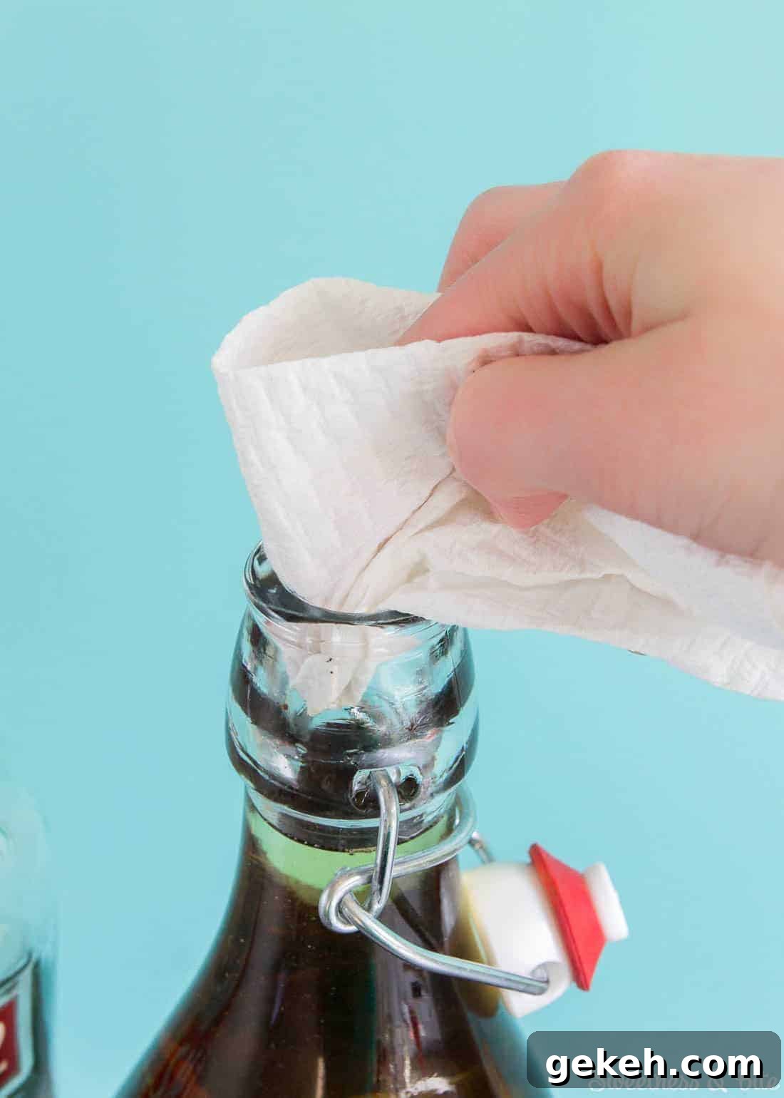 Homemade Vanilla Extract Infused with Rum: Step-by-Step Guide 8 A paper towel being used to clean the top of the bottle.
