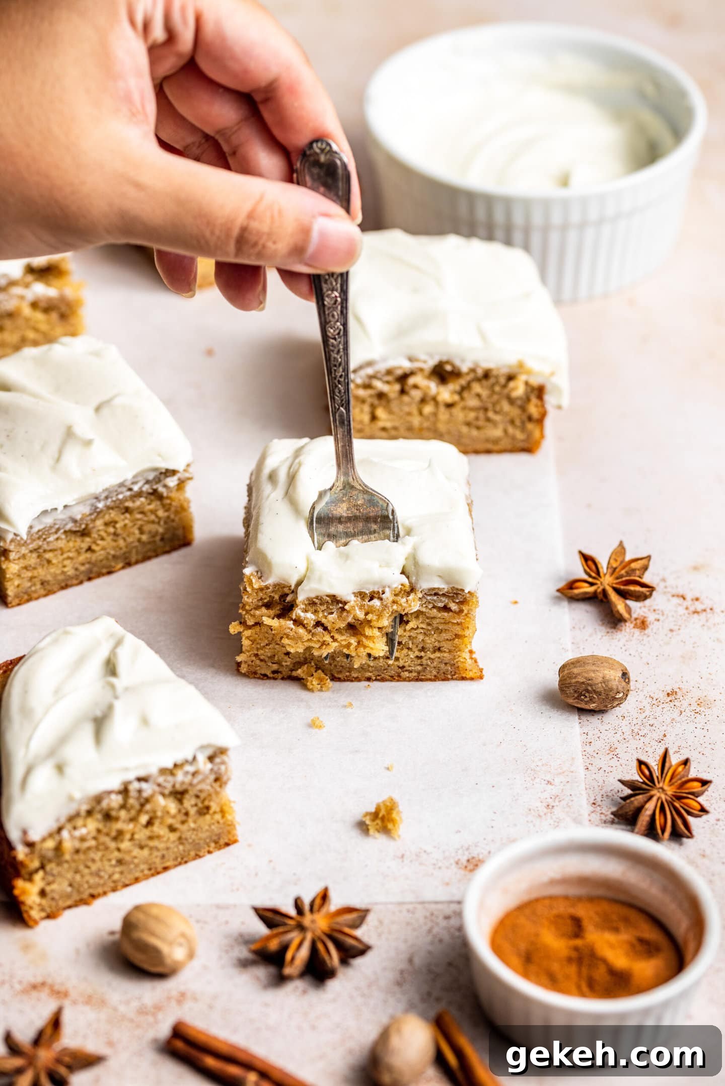 Spiced Banana Snack Cake Recipe for Moist, Flavorful Bites 6 Hand holding fork digging into a slice of Spiced Banana Snack Cake