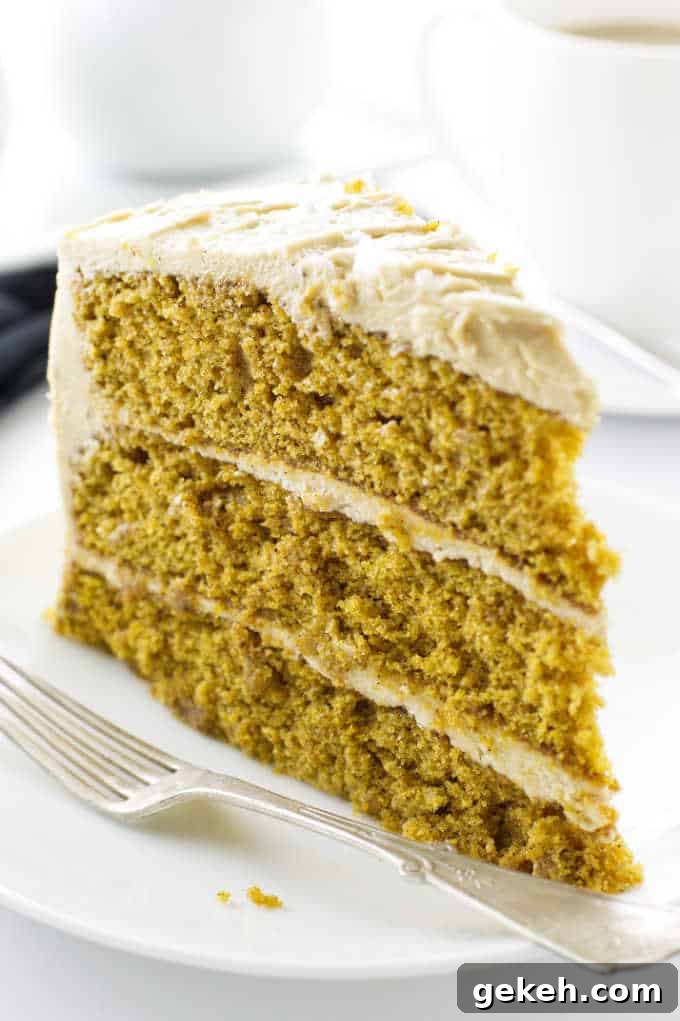 A slice of Pumpkin Spice Cake on a plate with fork