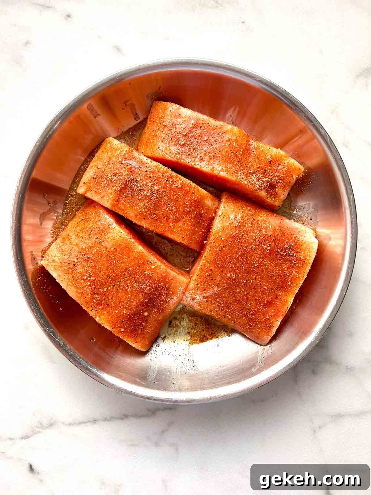 Crispy Air Fryer Salmon Recipe — Quick Flavorful Meal 4 salmon filets oiled and seasoned on dish.