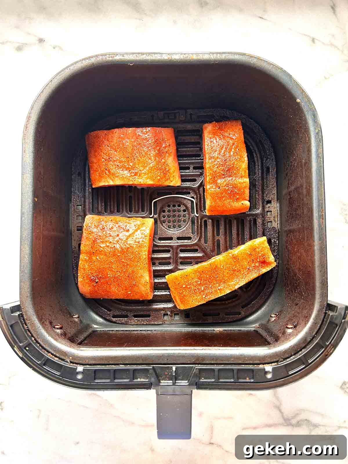 Crispy Air Fryer Salmon Recipe — Quick Flavorful Meal 5 salmon filets arranged in air fryer basket.