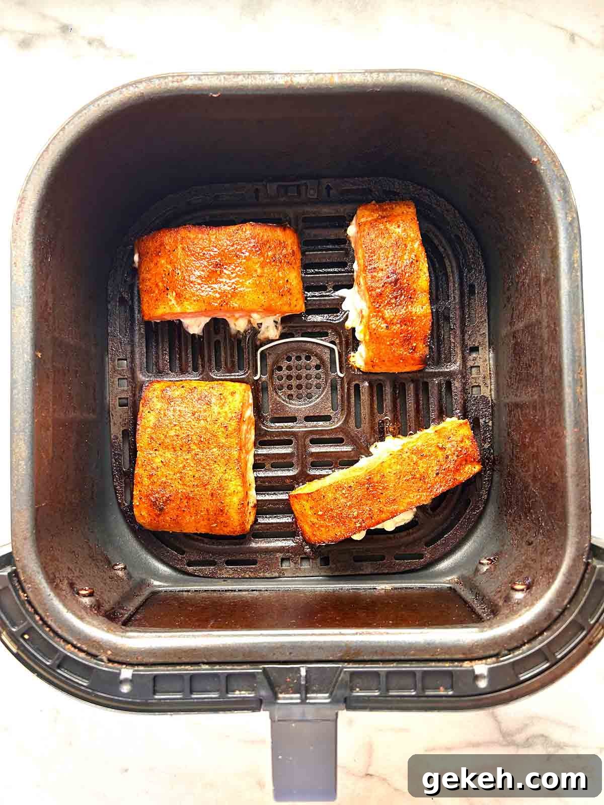 Crispy Air Fryer Salmon Recipe — Quick Flavorful Meal 6 salmon filets after being air-fried.