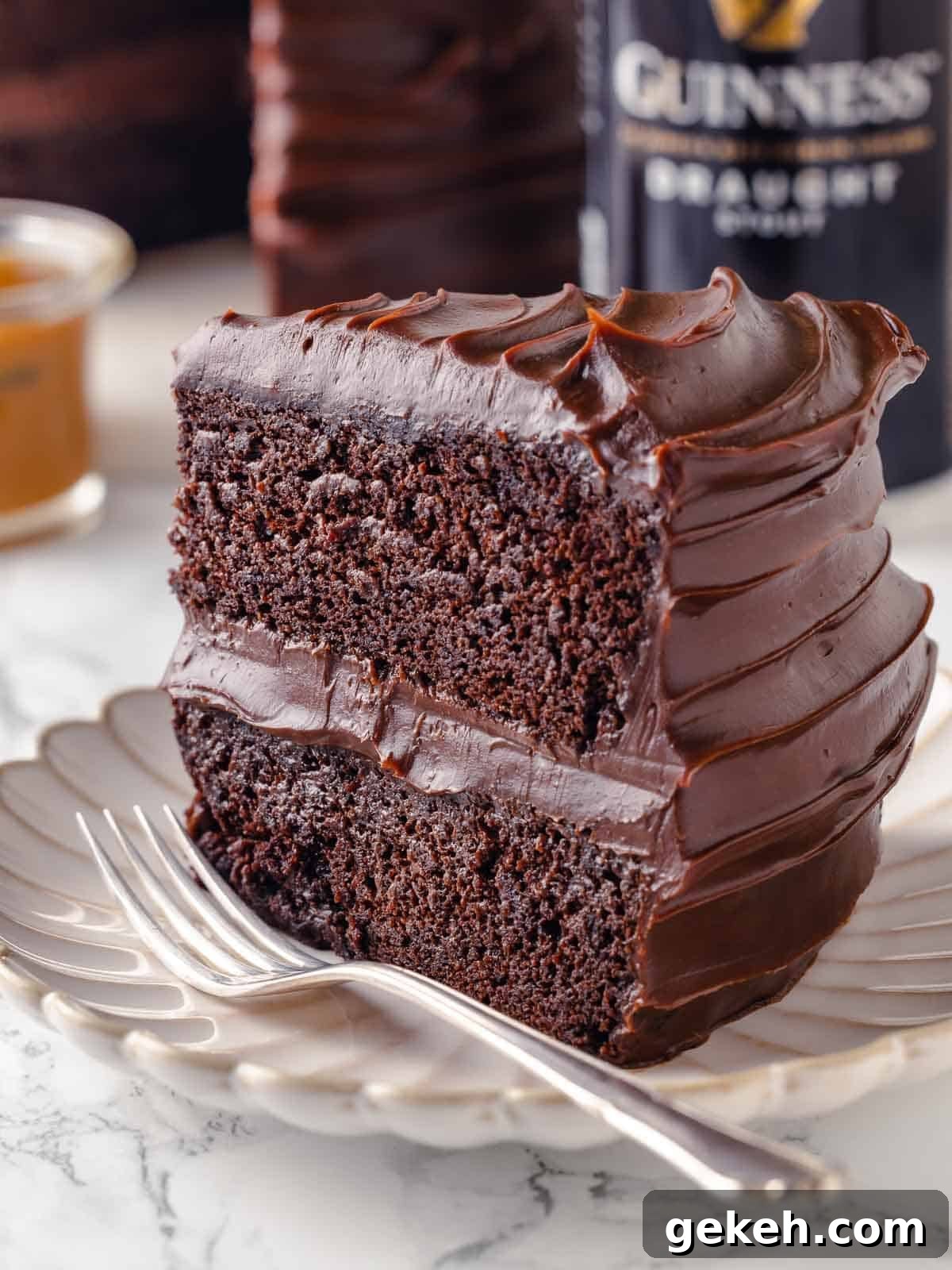Decadent Guinness Chocolate Cake Recipe with Rich Stout Frosting 2 slice of guinness chocolate cake with two layers on plate.