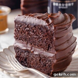 slice of guinness chocolate cake with two layers on plate with fork.