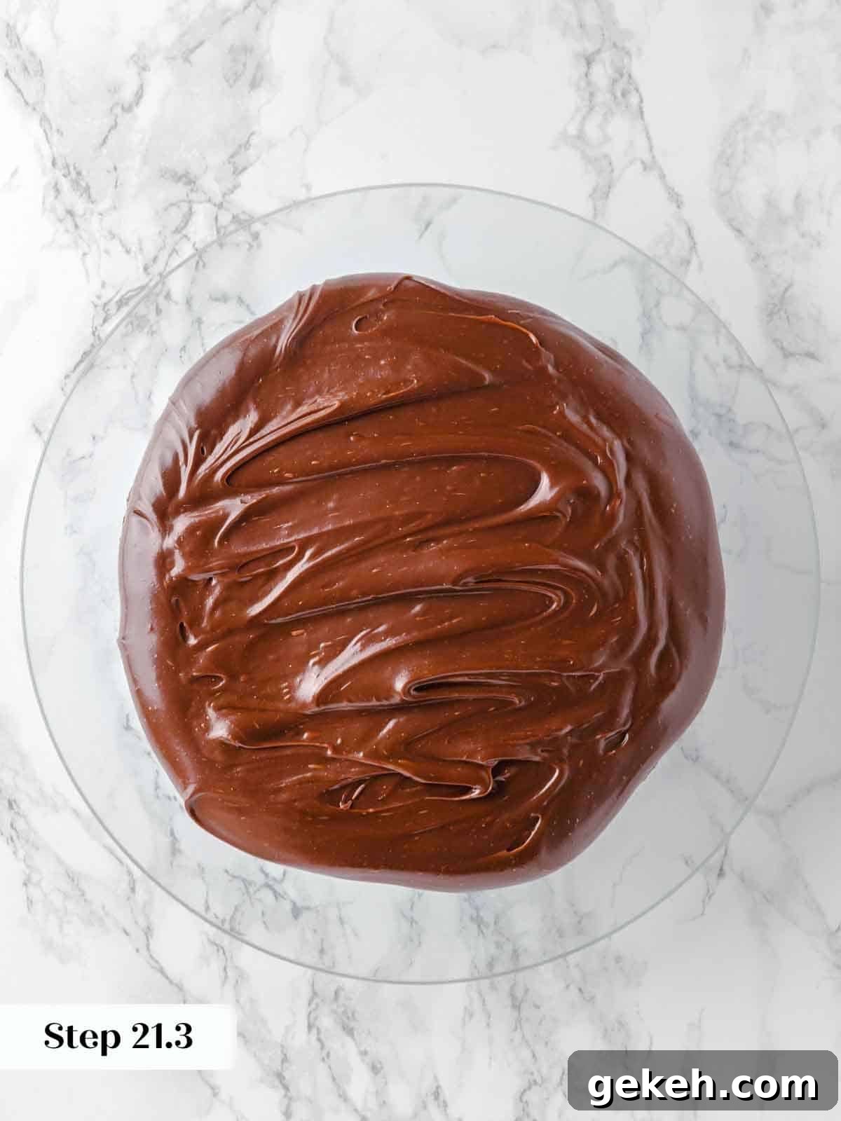 Decadent Guinness Chocolate Cake Recipe with Rich Stout Frosting 20 spreading frosting between layers of guinness chocolate cake during assembly.