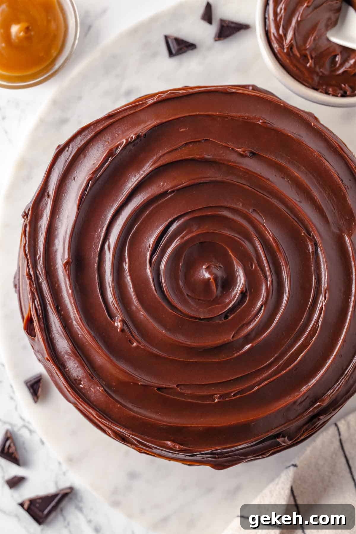 Decadent Guinness Chocolate Cake Recipe with Rich Stout Frosting 21 swirled caramel fudge frosting on guinness chocolate cake unsliced.