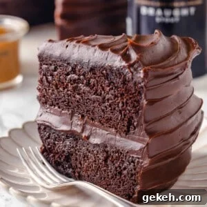 Decadent Guinness Chocolate Cake Recipe with Rich Stout Frosting 23 slice of guinness chocolate cake with two layers on plate with fork.