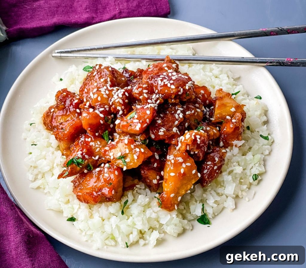 Keto Orange Chicken: Low-Carb Sticky Citrus Chicken Recipe 2 keto low carb orange chicken on a white plate with sesame seeds