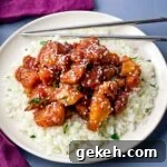 Keto Orange Chicken: Low-Carb Sticky Citrus Chicken Recipe 11 keto low carb orange chicken on a white plate with sesame seeds