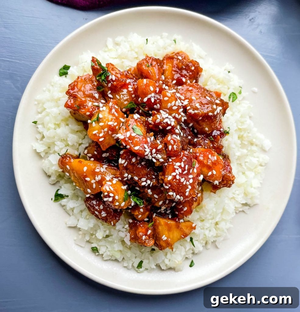 Keto Orange Chicken: Low-Carb Sticky Citrus Chicken Recipe 12 keto low carb orange chicken on a white plate with sesame seeds