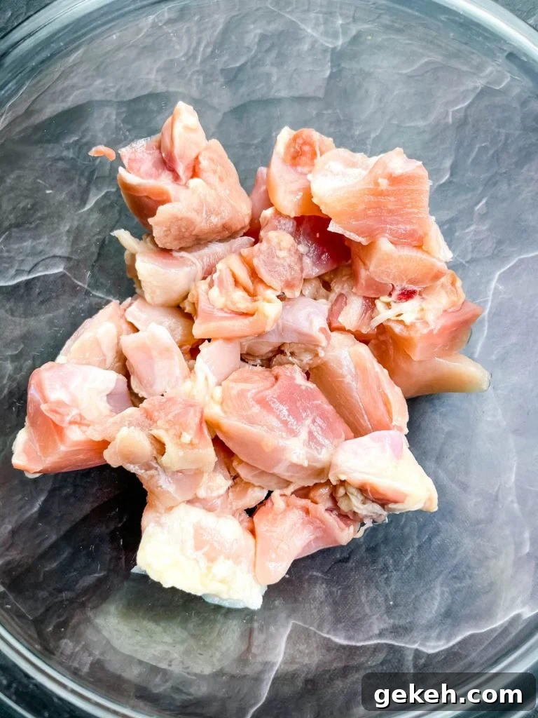 Keto Orange Chicken: Low-Carb Sticky Citrus Chicken Recipe 6 raw chicken thighs in a glass bowl