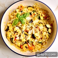 Roasted Vegetable and Parmesan Orzo Recipe 12 Orzo pasta with roasted vegetables and parmesan in a bowl.
