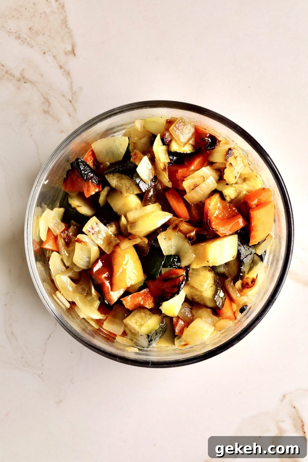Roasted Vegetable and Parmesan Orzo Recipe 8 How to make Easy Orzo Pasta with Roasted Vegetables and Parmesan- vegetables roasted and set aside in a glass bowl ready to add to your salad.