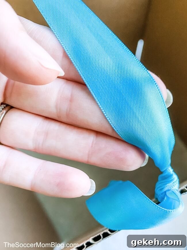 tying a ribbon on a cardboard box